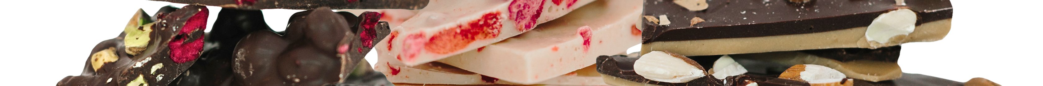Pieces of different chocolate barks on a white background