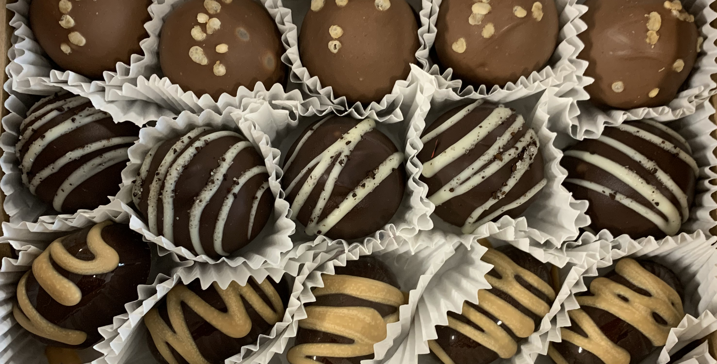 Saratoga Chocolate truffles in white paper cups close up photo