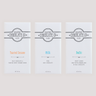 Three Saratoga Chocolate Co. milk chocolate bars in white wrappers with distinct labels: Toasted Sesame, Milk and Bodhi; arranged side by side on a light background.