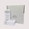 Stack of Saratoga Chocolate Co. bars arranged in front of a white box, with a Fleur de Sel Chocolate bar facing forward and prominently displayed.