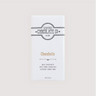 Wrapped Saratoga Chocolate Co. Chocoholic Bar in a white paper package with a brown flavor label. Label features the black Saratoga Chocolate Co. logo and describes the bar as creamy milk chocolate with dark chocolate-covered cacao nibs. This bar is gluten free.