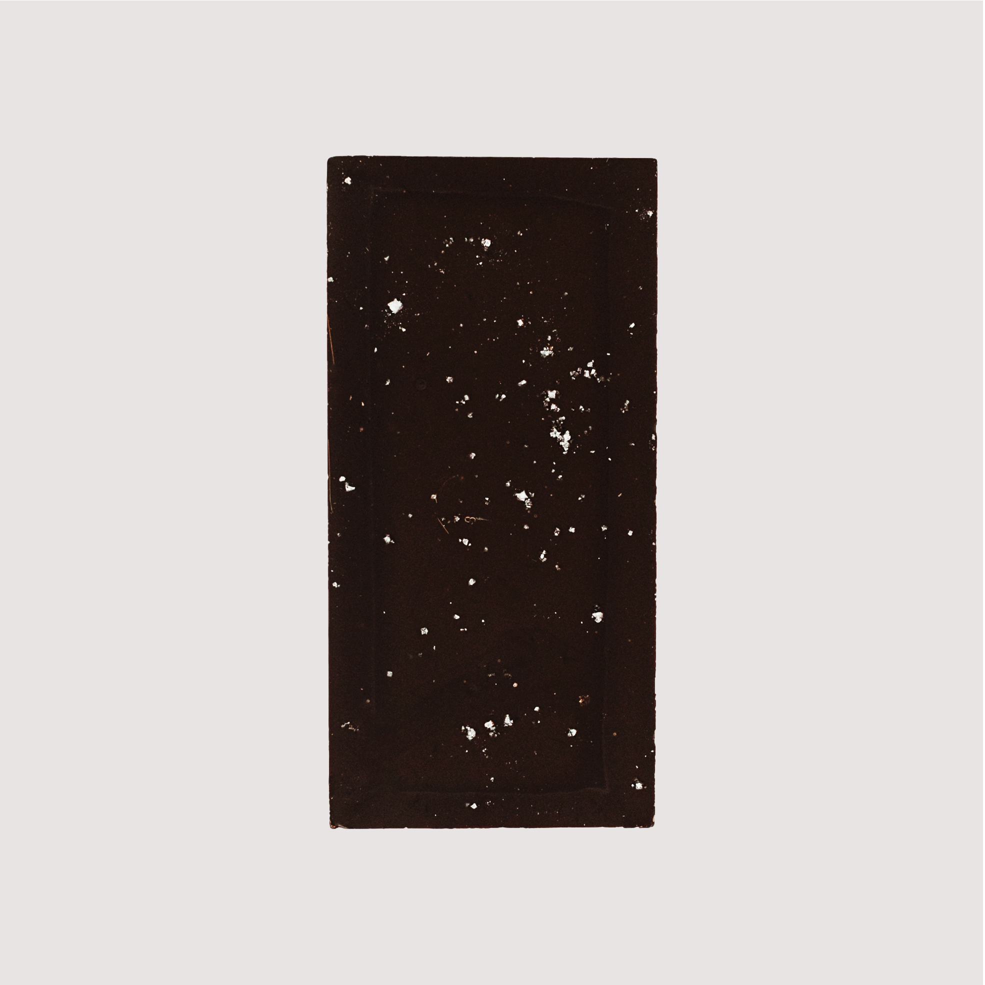 Unwrapped Saratoga Chocolate Co. Fleur de Sel Bar, back side revealing a textured surface with visible flakes of French sea salt sprinkled across the dark chocolate. This bar is vegan, gluten and dairy free.