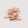 Stack of Saratoga Chocolate Co. Berries & Cream White Chocolate Bark pieces, featuring creamy white chocolate blended with freeze-dried strawberries and raspberries. This bark is gluten free.
