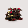 Stack of Saratoga Chocolate Co. Cherry Pistachio Dark Chocolate Bark pieces, featuring rich dark chocolate topped with freeze-dried cherries and roasted pistachios. This bark is vegan, gluten and dairy free.