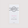 Front of Saratoga Chocolate Co. Fleur de Lait Bar wrapped in a white paper package with a pink flavor label. Label features the Saratoga Chocolate Co. logo and describes the bar as creamy milk chocolate with delicate flakes of French sea salt. This bar is gluten free.