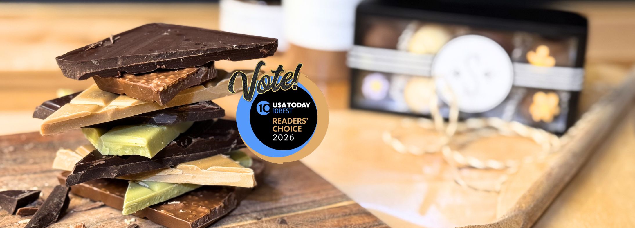 Stack of chocolate bars on a wooden surface with a 'Voted' badge in the background.