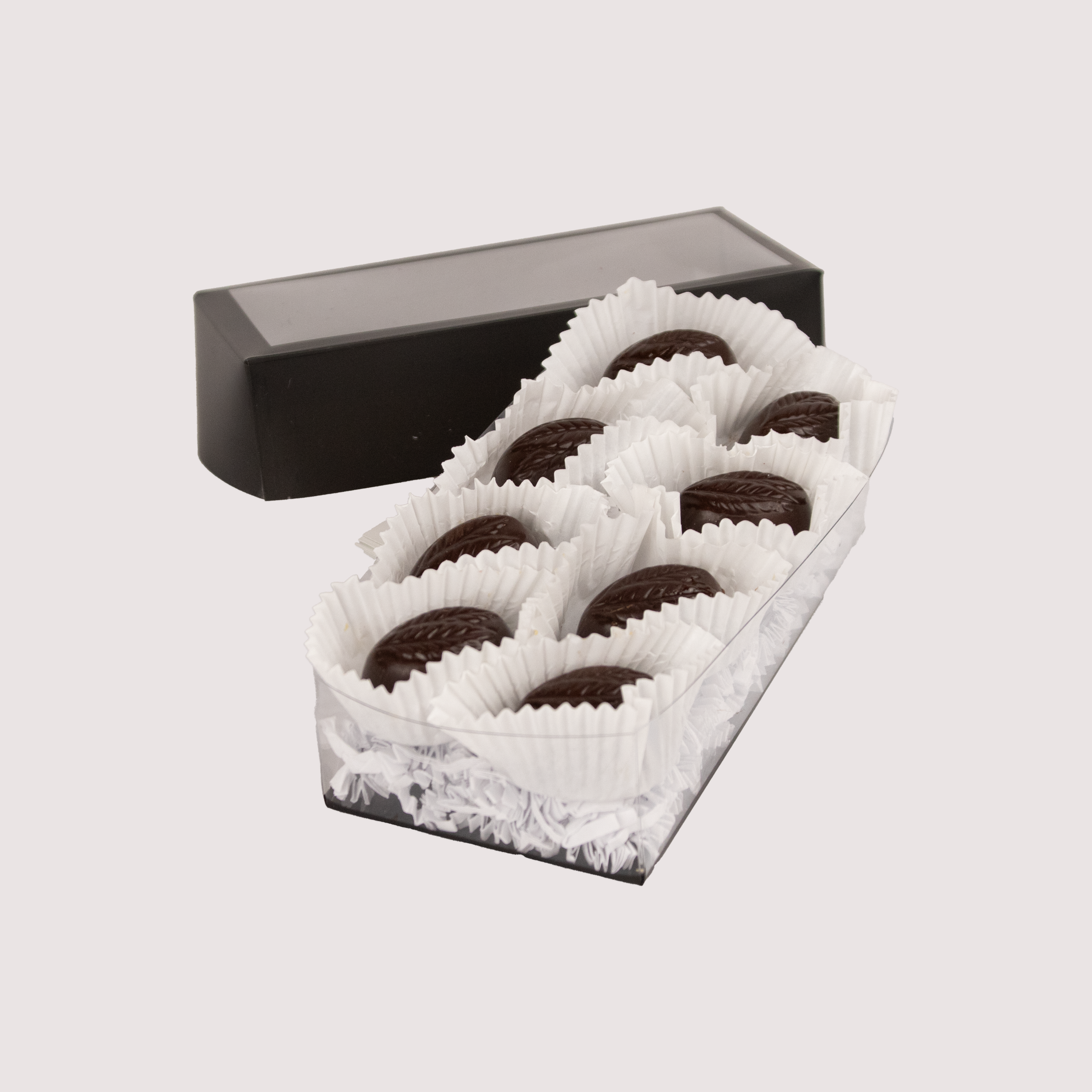 Saratoga Chocolate Co. Scotch Whisky Caramel Truffle Collection featuring eight dark chocolate truffles nestled in white paper cups within a clear box. Each truffle has a smooth dark chocolate shell encasing a soft, gooey caramel infused with smoky Scotch whisky.