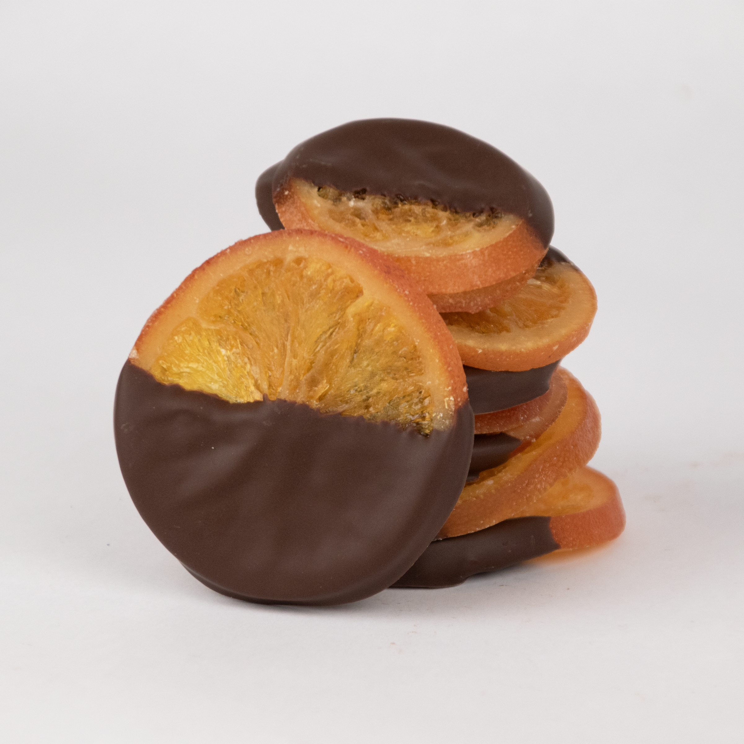 A stack of Saratoga Chocolate Co candied orange slices half-dipped in dark chocolate