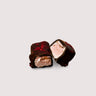 Chocolate-covered raspberry marshmallow with raspberry topping cut in halves on a light gray background