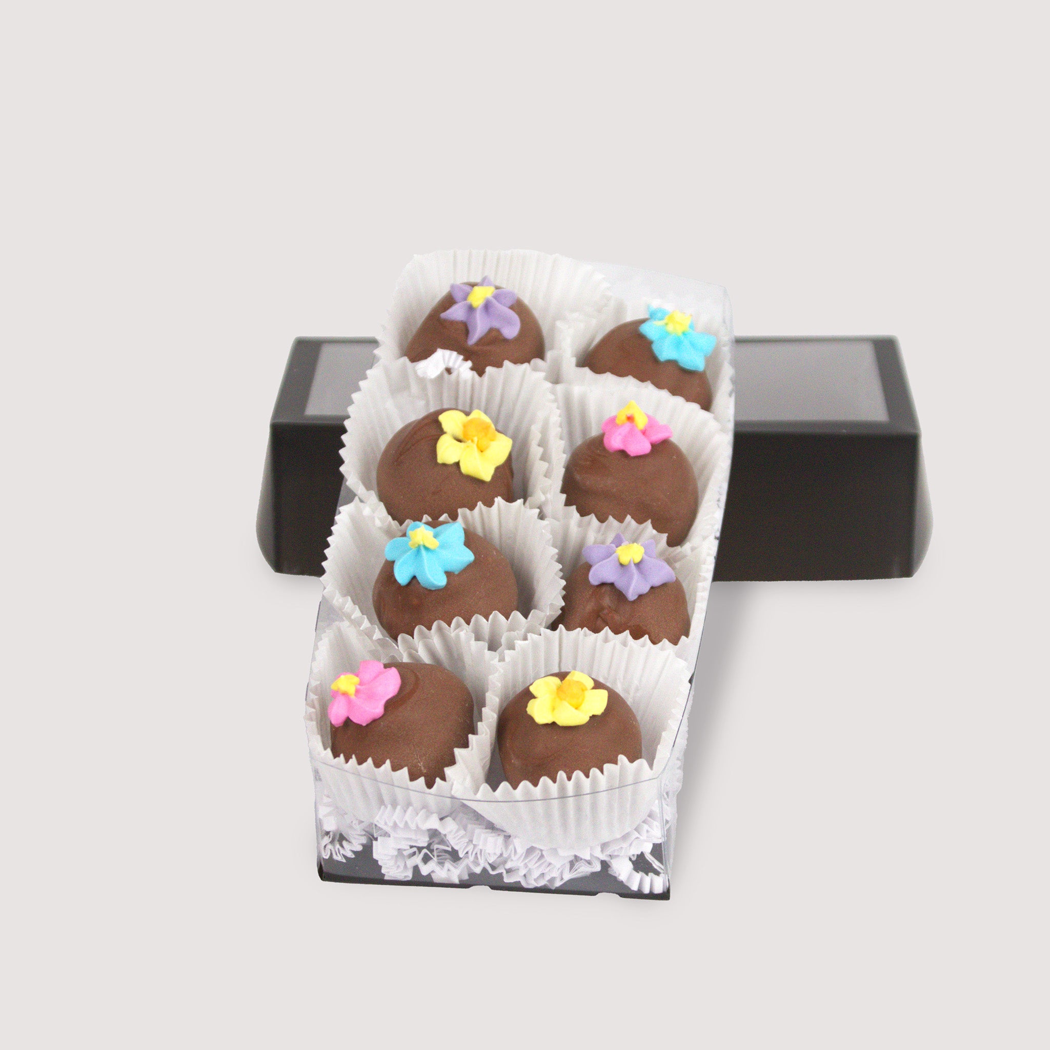 Box of eight Milk Chocolate Truffles, featuring smooth milk chocolate ganache inside creamy milk chocolate shells, topped with delicate hand-made sugar flowers — a rich and elegant treat from Saratoga Chocolate Co.
