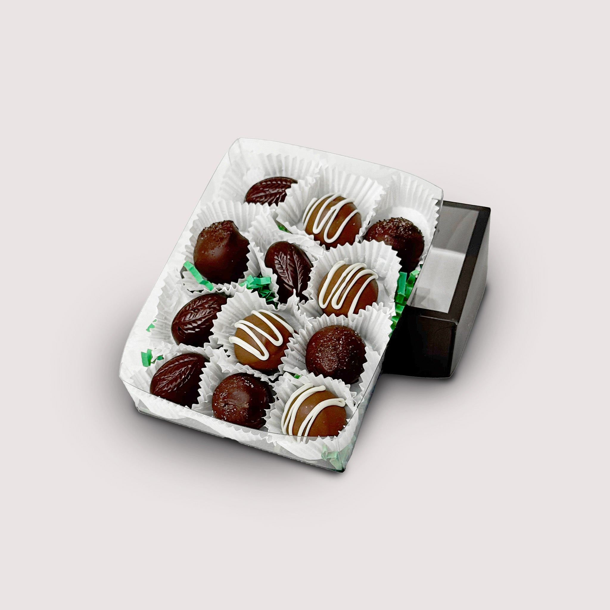 Box of 12 chocolate truffles (Irish Coffee, Irish Cream and Whiskey Caramel) on a light gray background