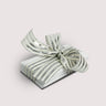 Stack of chocolate bars by Saratoga Chocolate Co with a silver and white striped bow on a light gray backgrounds 