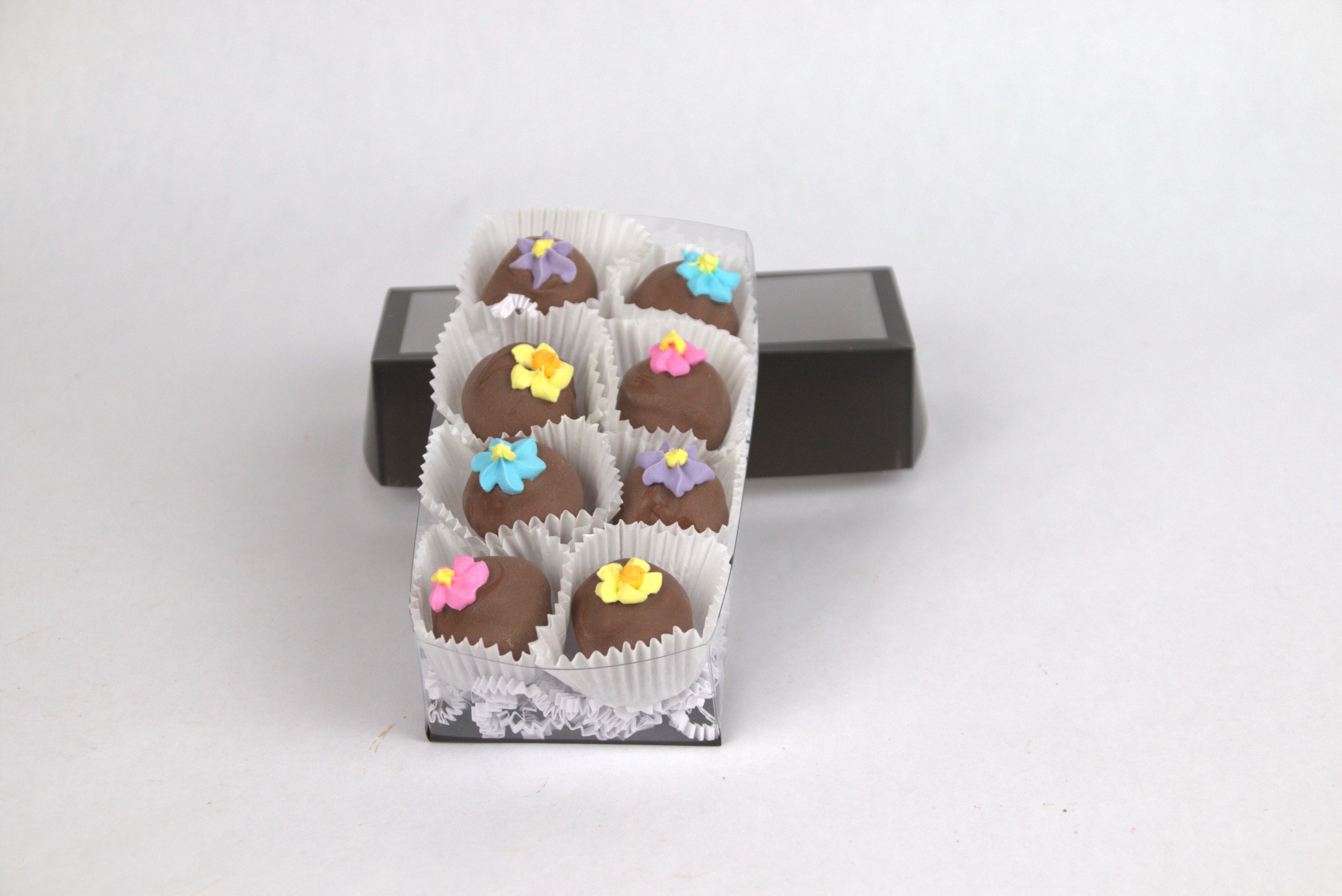 Box of eight Milk Chocolate Truffles, featuring smooth milk chocolate ganache inside creamy milk chocolate shells, topped with delicate hand-made sugar flowers — a rich and elegant treat from Saratoga Chocolate Co.