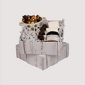 This distressed white wood style cardboard box is approximately 9 inches by 9 inches and three inches deep. Each box is filled with decorative white shredded paper and stuffed with a mini jar of dark chocolate hot chocolate, two freshly made pillow-soft, snow white vanilla marshmallows, four little dark chocolate caramel filled snowmen bonbons, powdered sugar dusted toffee chocolate covered pistachios, and a heaping serving of caramel corn with cacao nibs drizzled lightly in dark chocolate. 