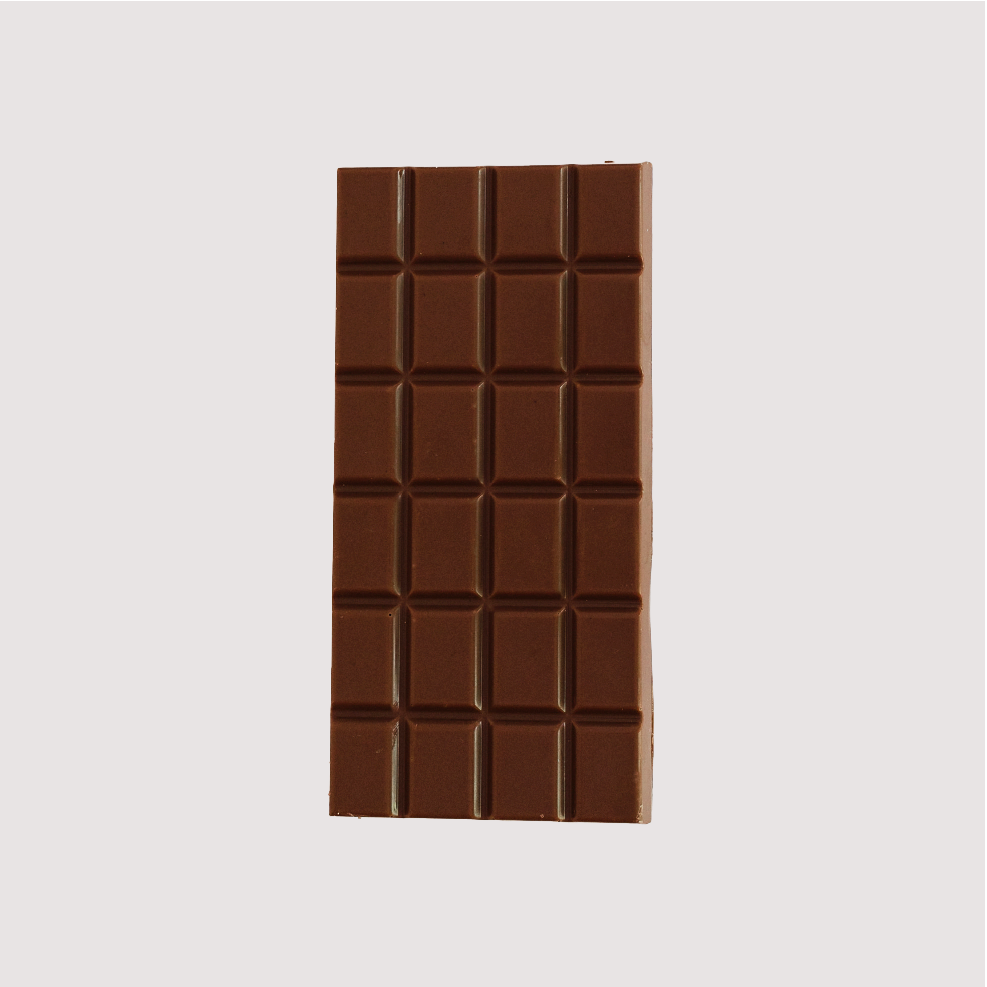 Unwrapped Saratoga Chocolate Co. Fleur de Lait Bar, front side showing a glossy milk chocolate surface divided into 24 square segments. This bar is gluten free.