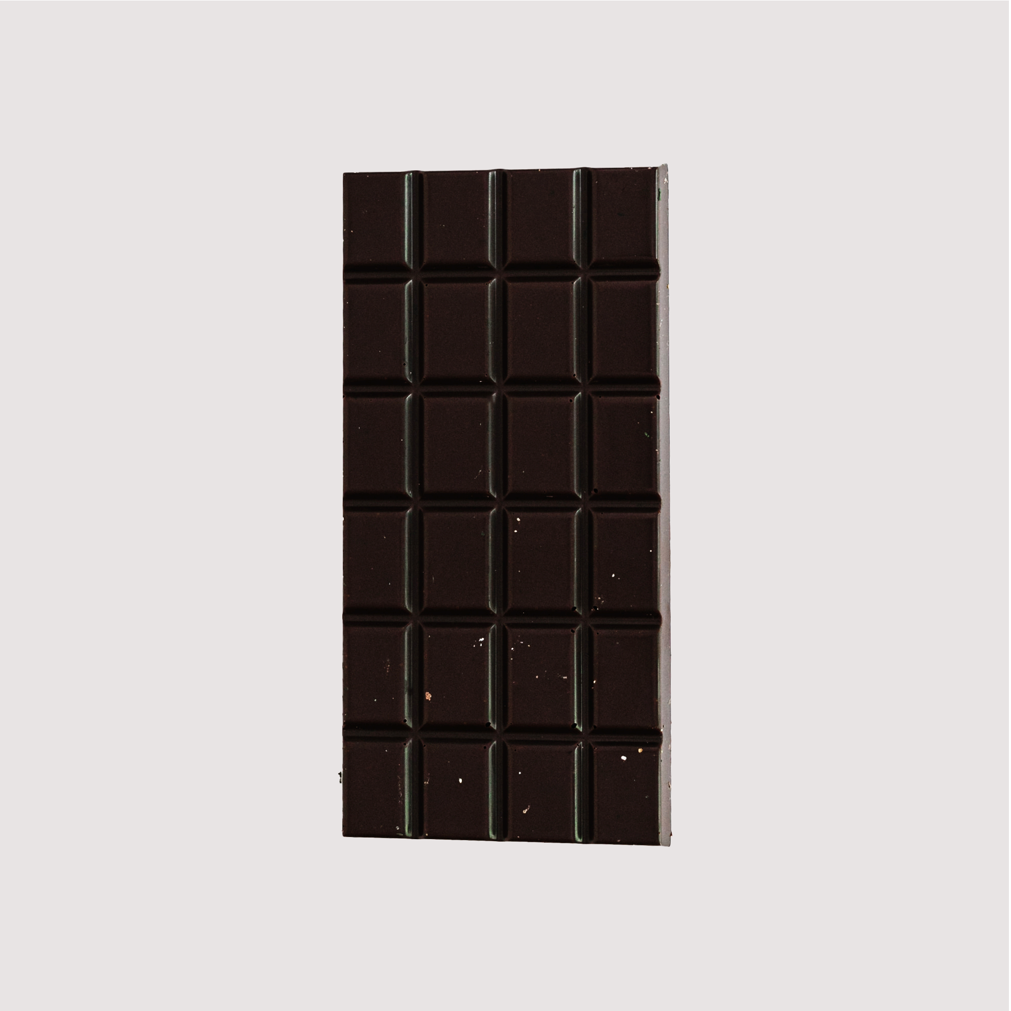 Unwrapped Saratoga Chocolate Co. Genmai Cha Bar, front side showing a smooth dark chocolate surface divided into 24 square segments. This bar is vegan, gluten and dairy free.