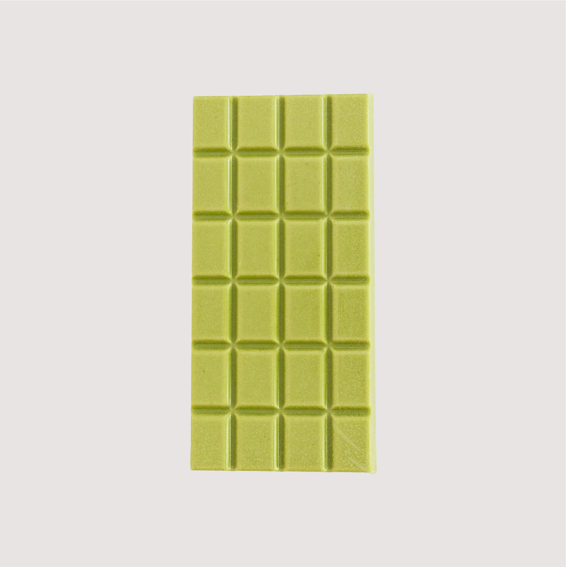 Unwrapped Saratoga Chocolate Co. Matcha Bar, front side showing a smooth green chocolate surface of blended white chocolate and matcha tea and divided into 24 square segments. This bar is gluten free.