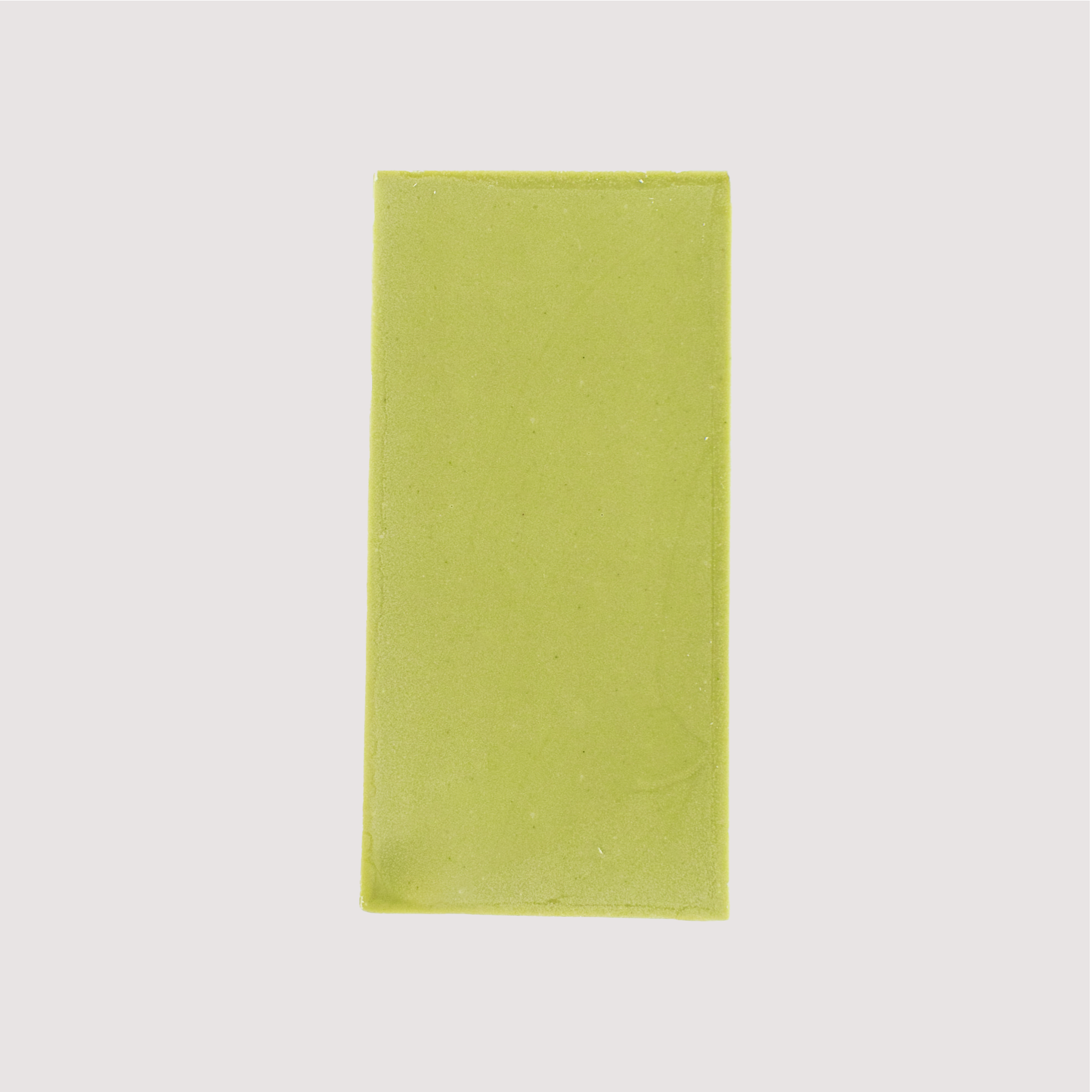 Unwrapped Saratoga Chocolate Co. Matcha Bar, back side showing a ssmooth green chocolate surface of blended white chocolate and matcha tea. This bar is gluten free.