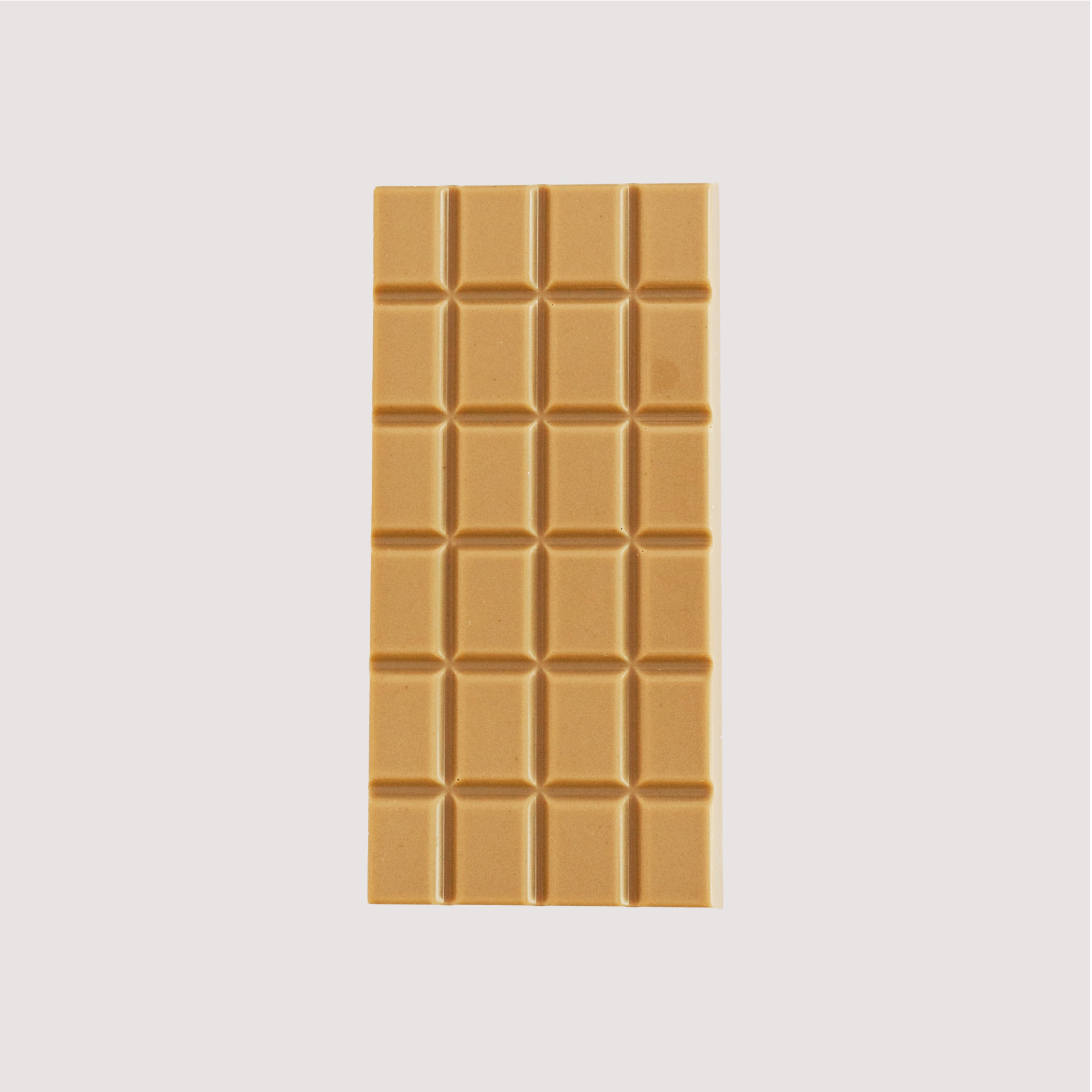 Unwrapped Saratoga Chocolate Co. Salted Caramel chocolate bar with a deep golden hue. The bar is made with caramelized sugar, giving it a rich color and creamy caramel flavor.